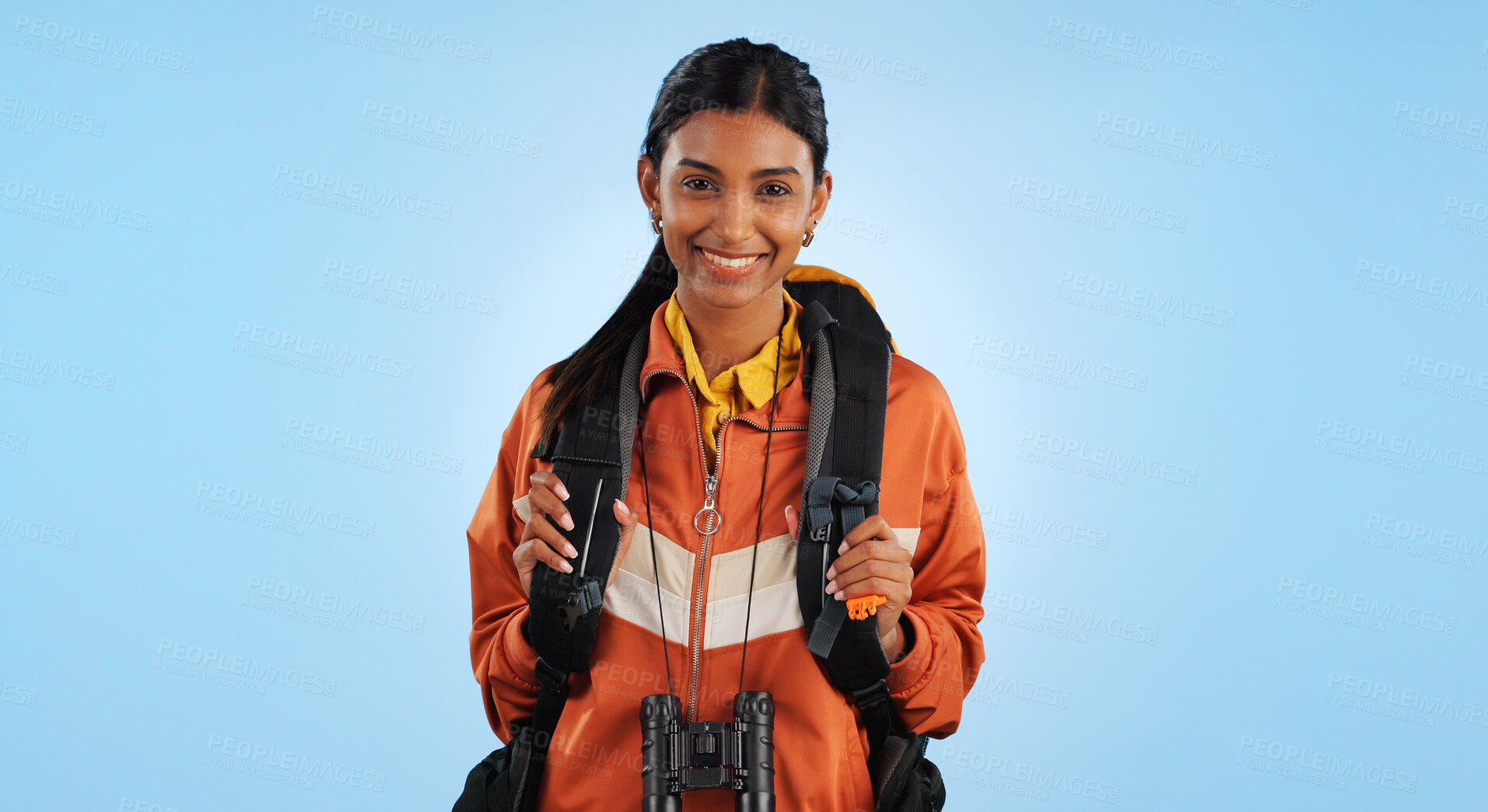 Buy stock photo Hiking studio, portrait and happy woman trekking, backpacking or travel for fitness, adventure or tourism holiday. Active tourist, smile or Indian person vacation, freedom or break on blue background