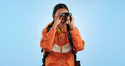 Hiking studio, binocular and woman watch trekking, backpacking and travel adventure view, sightseeing or bird watching. Wow, journey and happy camper vacation, freedom or discovery on blue background