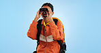 Hiking journey, binocular and studio woman watch trekking, backpacking or travel adventure view, sightseeing or bird watching. Wow, search discovery and explorer see destination on blue background