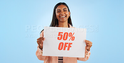 Woman, promotion poster and price portrait with sale, discount and billboard in studio. Excited, smile and happy from savings and deal paper with banner and promo with blue background and decrease