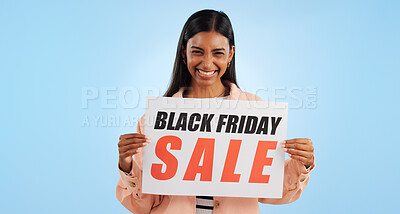 Buy stock photo Black friday, poster and woman portrait with sale, discount and billboard in studio. Excited, smile and happy from savings and deal paper with banner and promo with blue background and price decrease