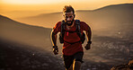 Contrasted shot of trail runner on mountain in sunset.
Fitness, sport, runner Concept.
