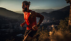 Contrasted shot of trail runner on mountain in sunset.
Fitness, sport, runner Concept.