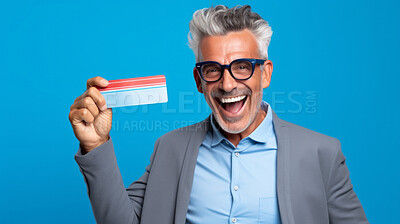 Buy stock photo Happy mature man holding a ticket or gift voucher. Excited male holding a blank card