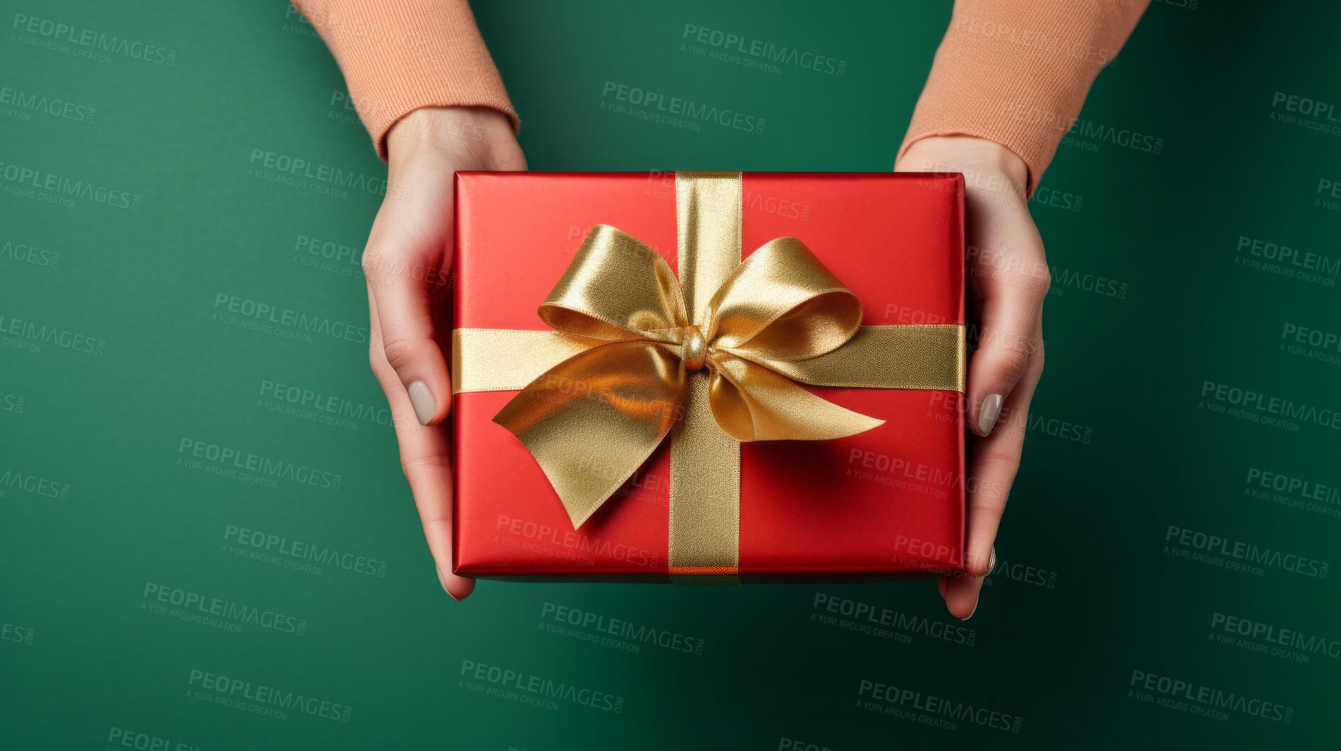 Buy stock photo Hand holding a red gift box with gold bow, on a green table. Valentine, Christmas or birthday