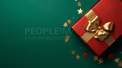 Red gift box with gold ribbon or bow on a green background. Valentine, Christmas or birthday