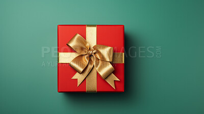 Red gift box with gold ribbon or bow on a green background. Valentine, Christmas or birthday