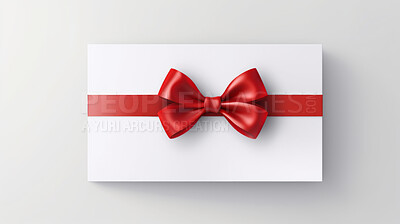 White gift card with red bow on a plain white background. Voucher or birthday gift