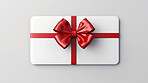 White gift card with red bow on a plain white background. Voucher or birthday gift