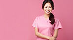 Friendly medical doctor or nurse in pink uniform scrubs on copyspace background.