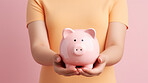 Hands holding a piggy bank. Savings, budget and money management concept