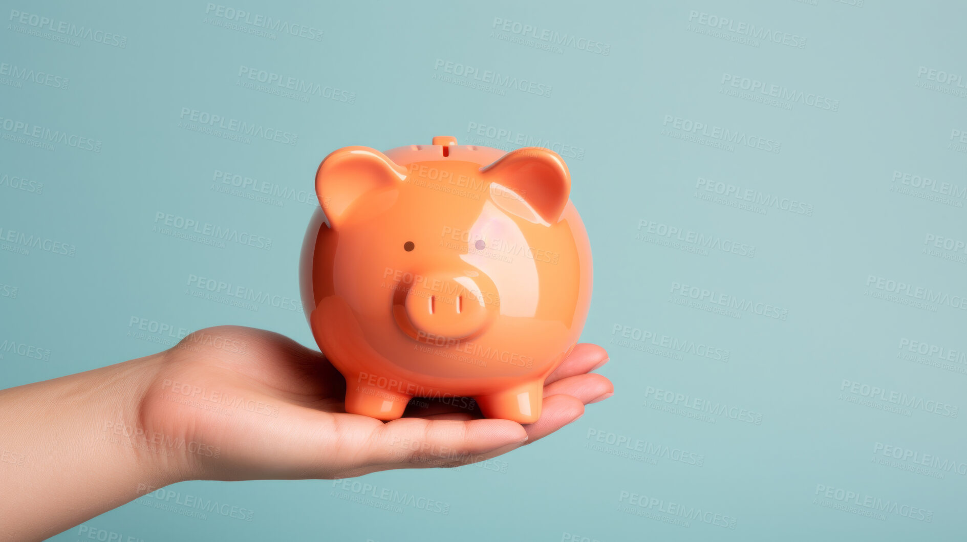 Buy stock photo Hand holding a piggy bank. Savings, budget and money management concept