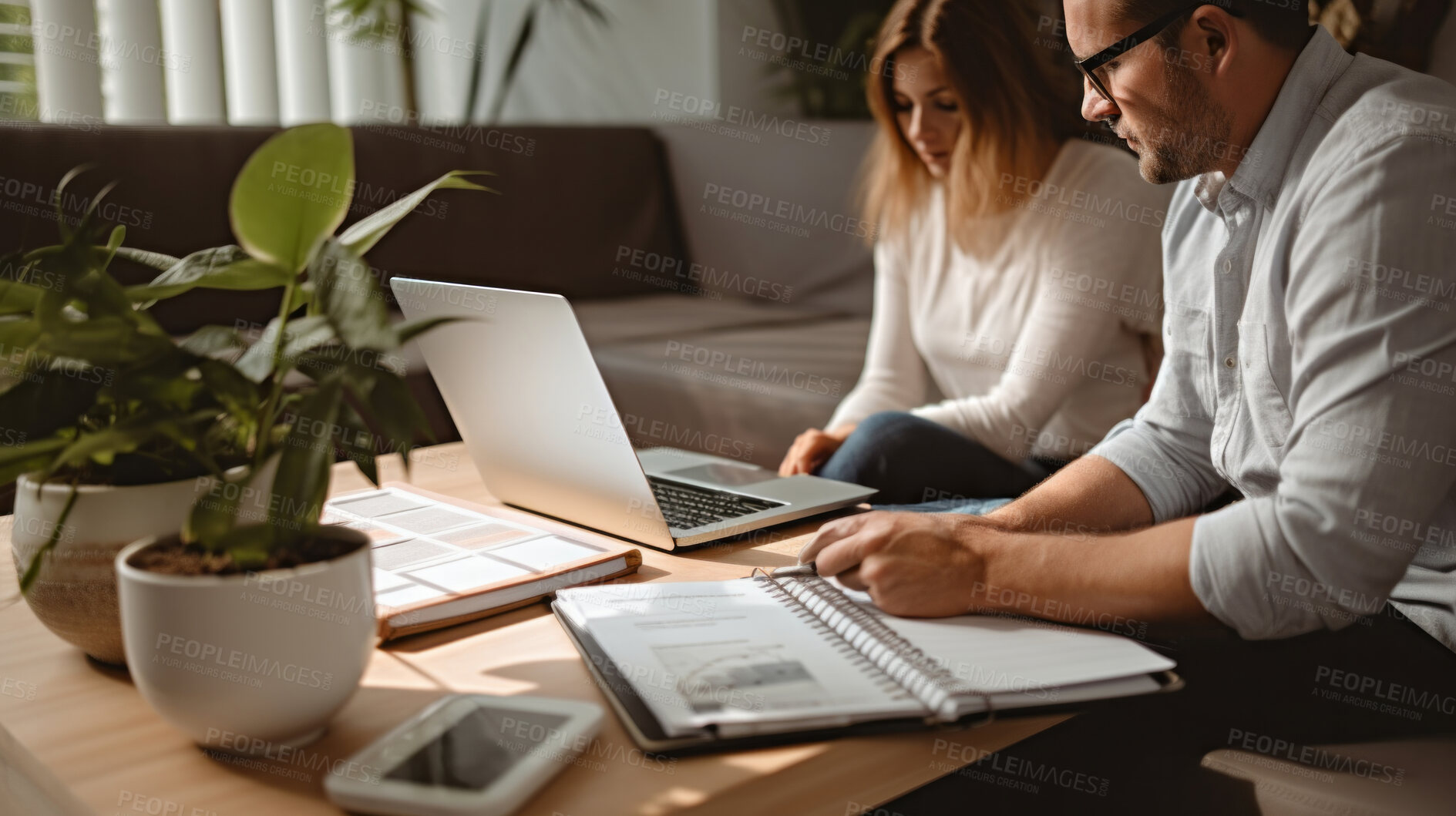 Buy stock photo Couple managing finance with wireless technology. Shot of couple using a laptop