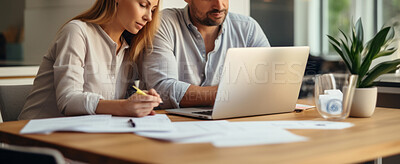 Couple managing finance with wireless technology. Shot of couple using a laptop