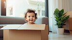 Toddler baby inside a box. Moving in concept. New home or relocation, investment