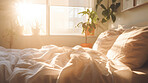 Sunlight on bed in simple bright bedroom. Cozy home interior design