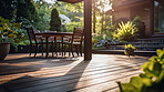 Sunlight on home backyard patio. Terrace design idea with table and chairs.