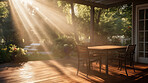 Sunlight on home backyard patio. Terrace design idea with table and chairs.