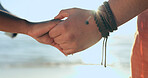 Love, zoom and couple holding hands at a beach with respect, gratitude and trust in nature together. Commitment, closeup and people together at sea with support, kindness and summer travel freedom