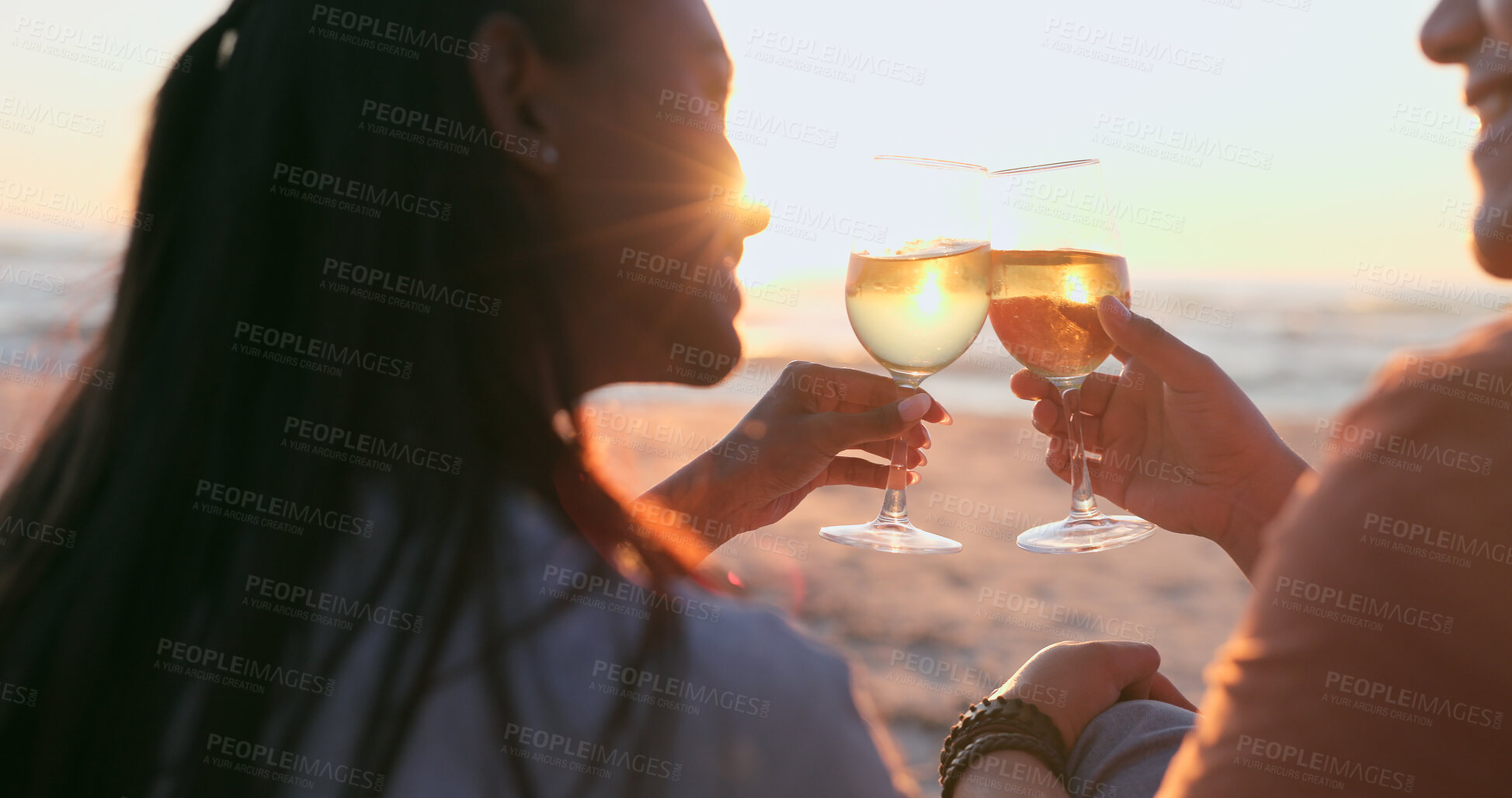 Buy stock photo Sunshine, beach and couple with wine, toast and anniversary with happiness, marriage or vacation. Romance, man or woman with alcohol, cheers or relationship with seaside holiday, lens flare or summer