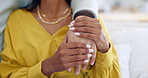 Couple, closeup and holding hands on sofa in home living room together for support, bonding and love with care. People, helping and consulting for empathy, kindness and connection with trust in house