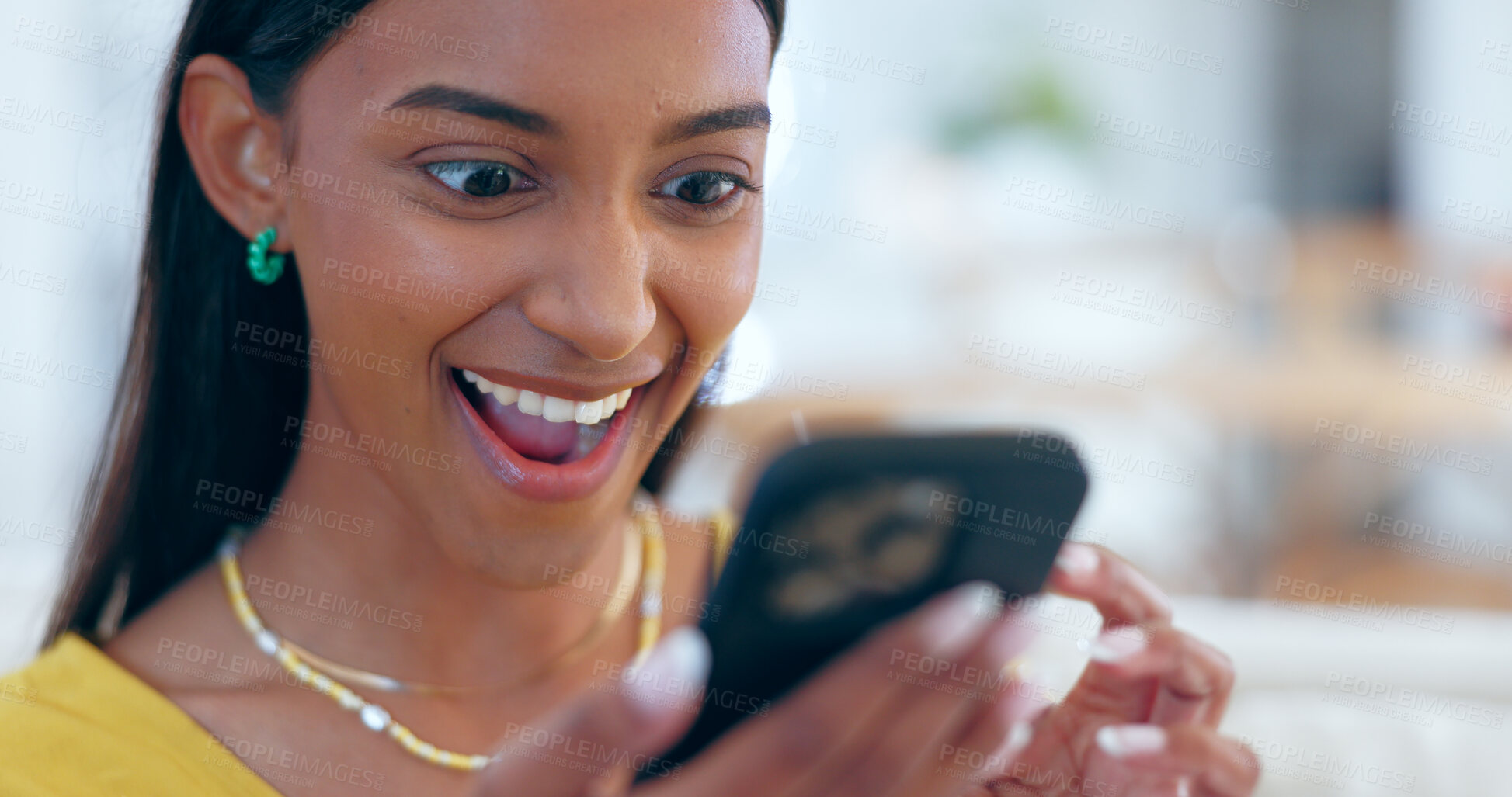 Buy stock photo Surprise, happy and woman networking on a phone on sofa in the living room reading gossip. Excited, shock and young Indian female person scroll on social media or the internet with cellphone at home.