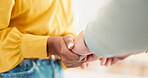 Couple, closeup and holding hands in house together for support, bonding and love with care for communication. People, helping and link for empathy, kindness and connection with trust in apartment