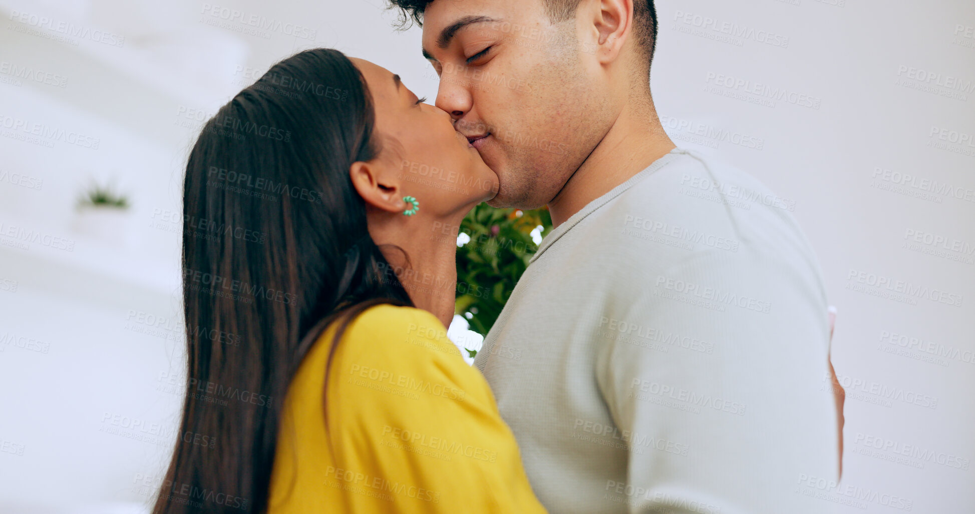 Buy stock photo Love, hug and a couple kissing closeup in their home for romance while bonding together on their anniversary. Face, happy or relationship with a man and woman embracing for care on valentines day