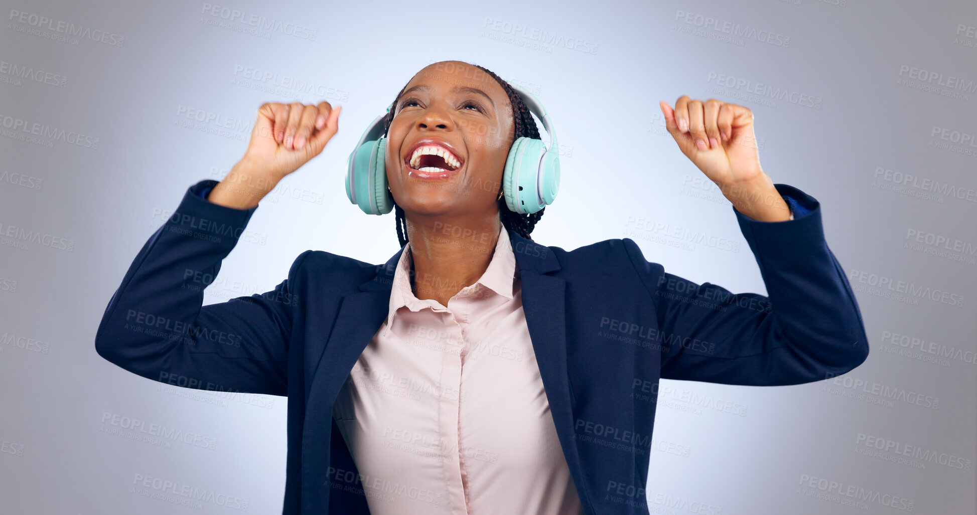 Buy stock photo Dance, business and happy woman with headphones in studio for celebration, freedom and success for winning on grey background. Excited african worker listening to music, audio and sound with energy