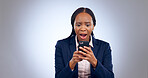 Wow, phone and confused black woman with omg face in studio with fake news, review or feedback on grey background. Surprise, anxiety and African entrepreneur shocked by social media, hacker or spam