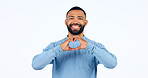 Heart, hands and portrait of man in studio for kindness, happy icon and charity donation on white background. Smile, love and emoji sign for hope, wellness and thank you for support, care and peace 