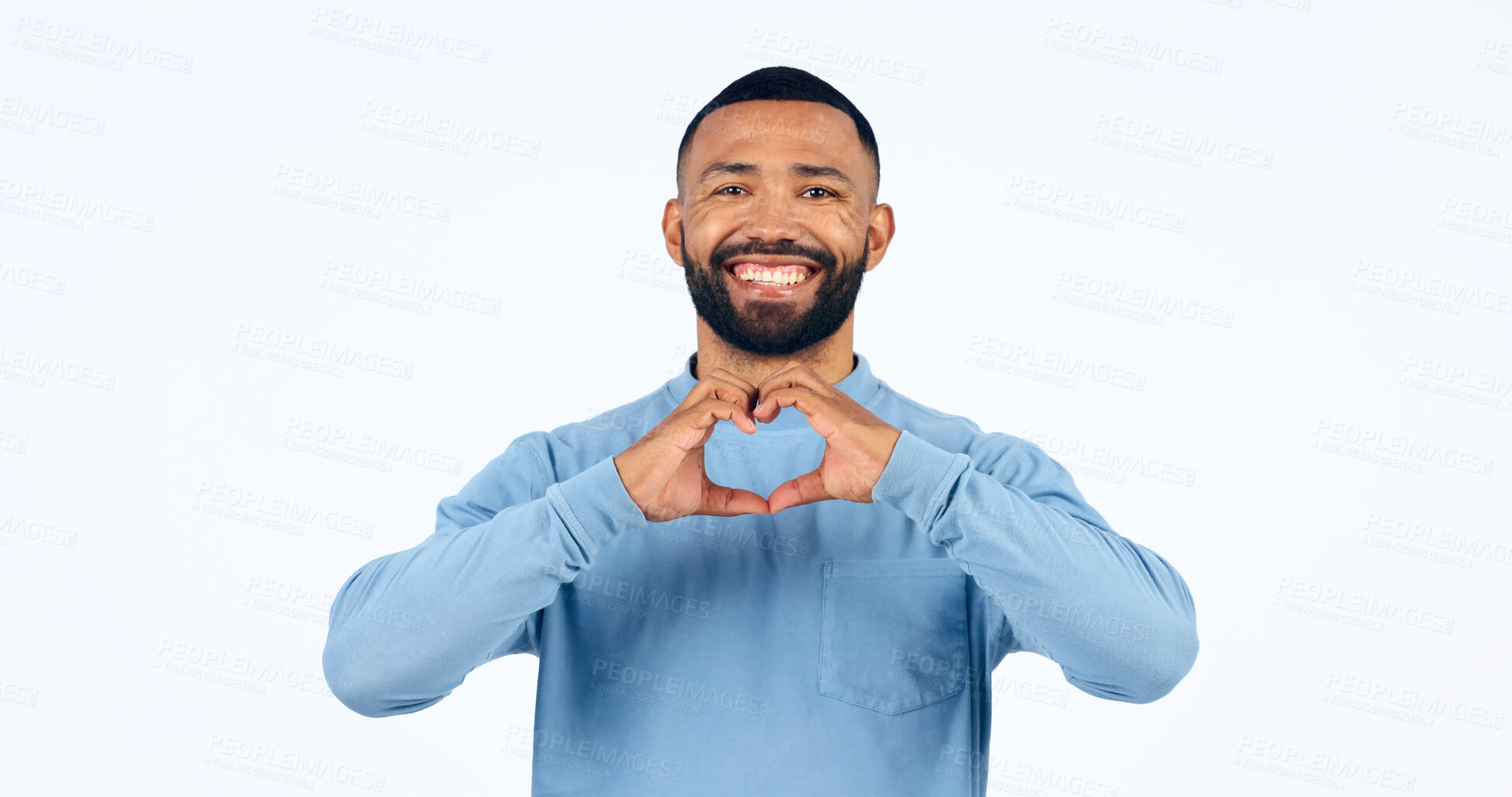 Buy stock photo Heart, hands and portrait of man in studio for kindness, happy icon and charity donation on white background. Smile, love and emoji sign for hope, wellness and thank you for support, care and peace 