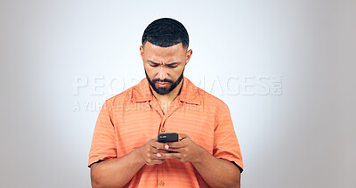 Buy stock photo Confused, text and man in studio reading fake news, email or error notification on grey background. Doubt, smartphone and male model with with app password glitch, 404 or phishing, scam or review