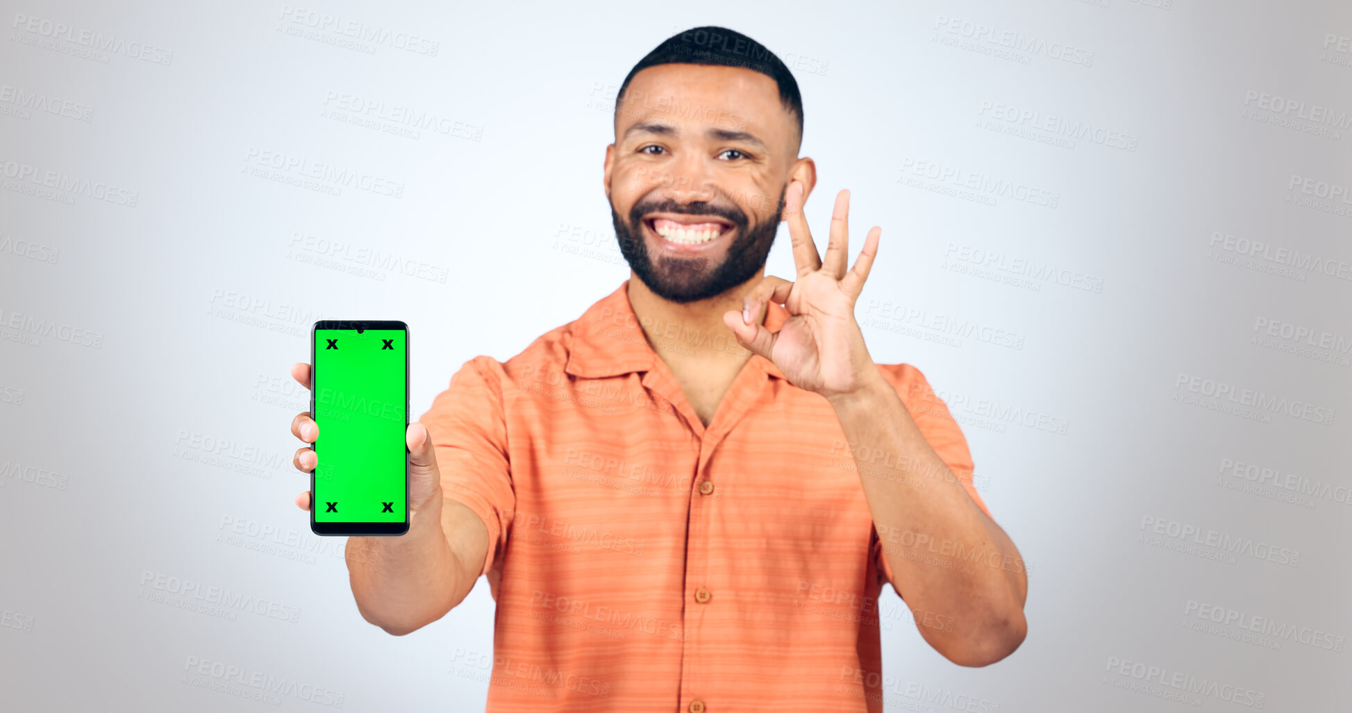 Buy stock photo Man, portrait and ok for phone with green screen, space or agreement in studio on white background. Happy model, smartphone or yes emoji for certified newsletter, promotion or advertising information