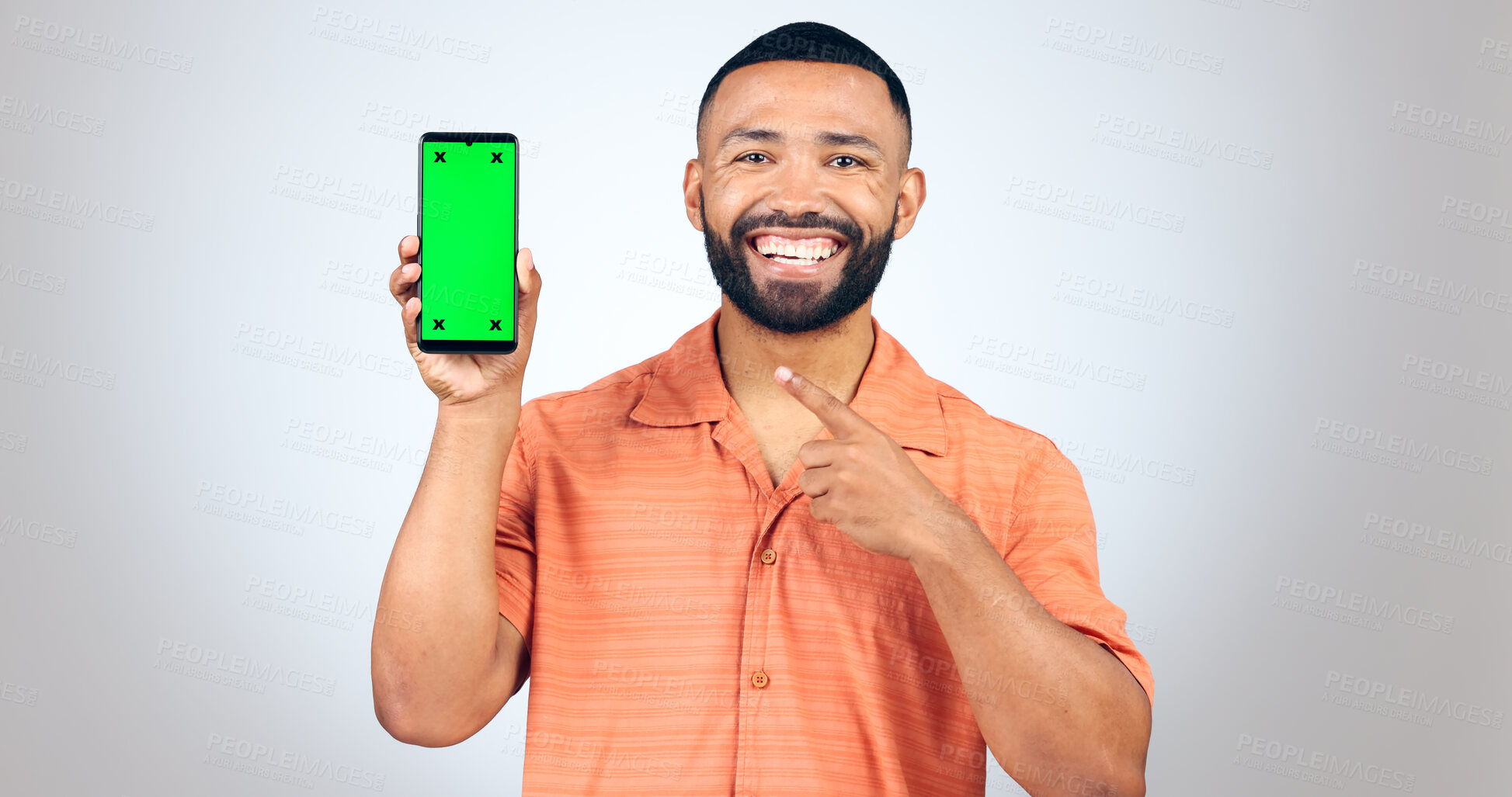 Buy stock photo Man, portrait and pointing to green screen of phone for advertising space, sign up offer or mockup newsletter in studio. Smartphone, announcement or digital marketing of promotion on white background