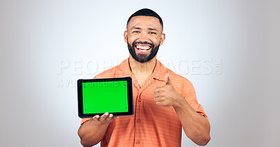 Buy stock photo Portrait, man and thumbs up for tablet with green screen, space or agreement of deal in studio on white background. Happy model, digital marketing and like emoji for newsletter, promotion and support