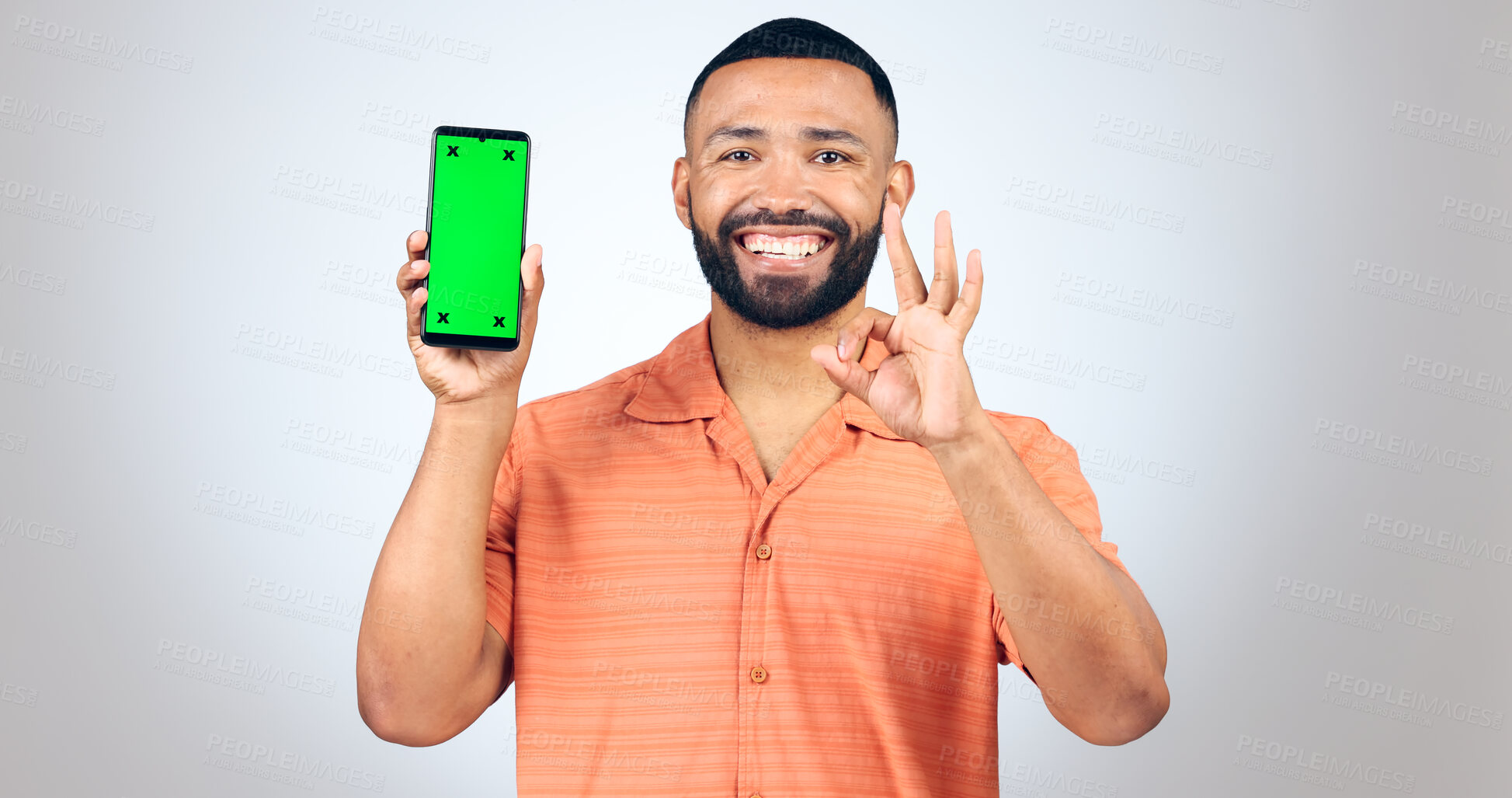 Buy stock photo Portrait, man and okay for phone with green screen, space and agreement sign in studio on white background. Happy model, smartphone and yes emoji for certified news, promotion or advertising feedback