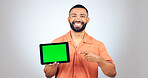 Man, portrait and pointing to green screen on tablet for advertising space, sign up offer and mockup newsletter in studio. Digital marketing, happy announcement and show promotion on white background