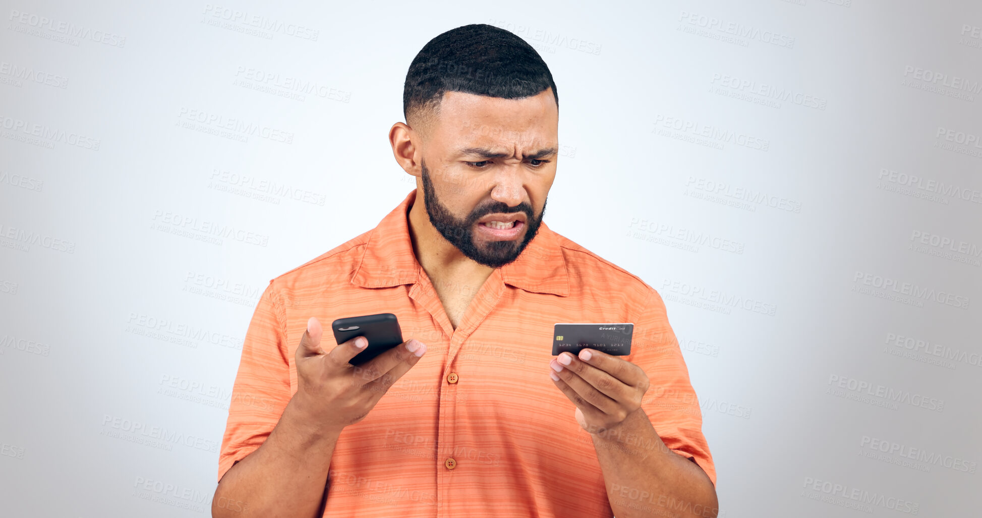 Buy stock photo Man in studio with phone, credit card and frustrated with connection problem, debt or glitch. Fintech, anger or confused person with smartphone for banking, online shopping or 404 on white background