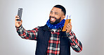 Selfie, travel and passport with a man tourist in studio on a gray background for vacation memories. Smile, id or boarding pass with a happy young person taking a profile picture on a holiday trip