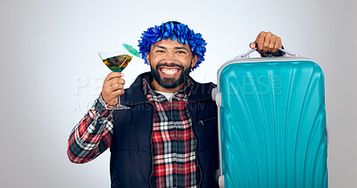 Buy stock photo Portrait, cocktail and suitcase for travel with a man in studio on a gray background for holiday or vacation. Smile, alcohol and luggage with a happy young tourist drinking in celebration of a trip