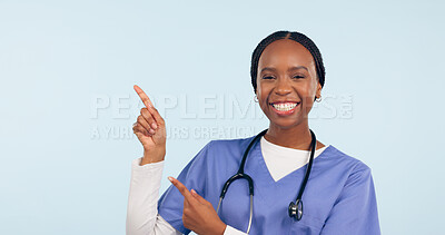 Buy stock photo Black woman, nurse and pointing at medical information, list or announcement with smile in portrait on blue background. Healthcare news, advertising and mockup for health alert and about us in studio