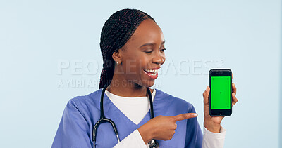 Buy stock photo Green screen, doctor and woman with phone pointing for telehealth, wellness app and medical news. Healthcare, mockup and person on smartphone for clinic website, online promo and contact in studio
