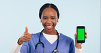 Green screen, thumbs up and portrait of doctor with phone for telehealth, wellness app and medical news. Healthcare, mockup and woman with hand sign on smartphone for website in studio background
