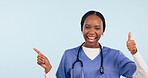 Happy black woman, portrait and thumbs up pointing in advertising against a studio background. African female person, nurse or surgeon showing information, like emoji or yes sign on mockup space