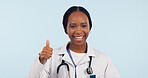 Black woman, doctor with thumbs up and agreement, healthcare in portrait on blue background. Hand gesture, emoji and medical feedback or review, like or yes with health promotion and smile in studio