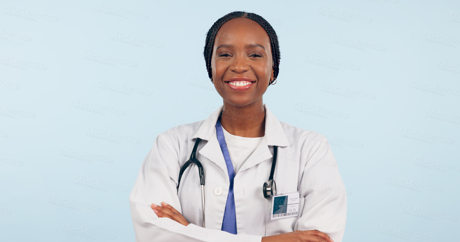 Buy stock photo Happy black woman, portrait and professional doctor with arms crossed on a studio blue background. Face of African female person, surgeon or medical nurse smile in confidence for healthcare on mockup