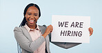 Business woman, hiring sign and studio portrait with smile for recruitment, welcome or search by blue background. African manager, human resources expert or poster for talent, employee or opportunity