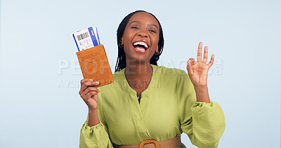 Buy stock photo Black woman, passport and ok sign for studio portrait with airplane ticket, documents and excited by blue background. Girl, paperwork and emoji for compliance, immigration and international travel