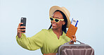 Black woman, selfie with suitcase and passport for travel, vacation and social media post on blue background. Luggage, smile in picture with plane ticket and booking documents for adventure in studio